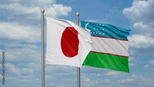 Republic of Uzbekistan and Japan two flags waving together, looped video, two country cooperation concept photo