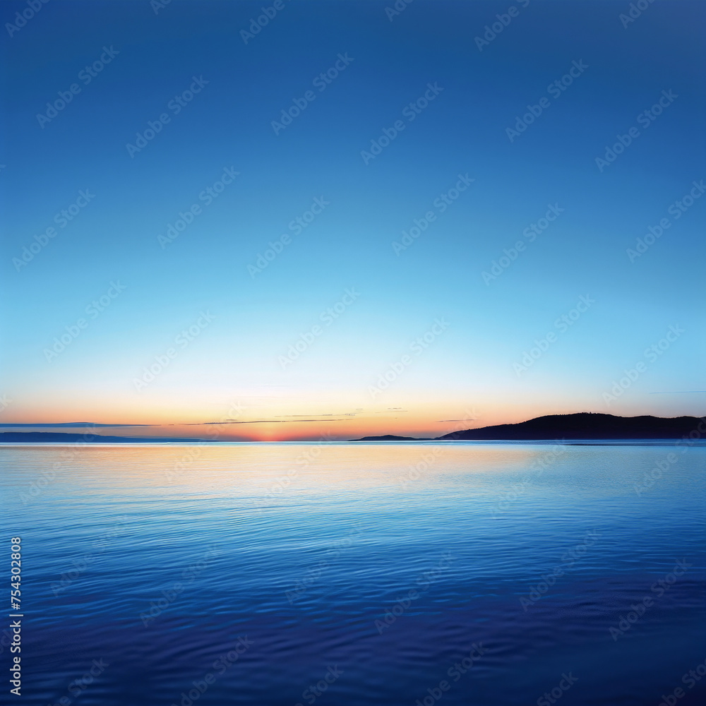 A beautiful blue ocean with a sunset in the background