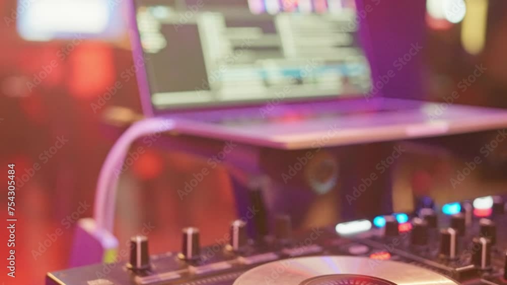 Exciting video showcasing a DJ playing music at a lively party in a club. Includes close ups of DJs controller, turntable, and mixer with CDs. High energy and vibrant atmosphere Exciting video showcasing a DJ playing music at a lively party in a club. Includes close ups of DJs controller, turntable, and mixer with CDs. High energy and vibrant atmosphere