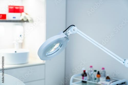 Cosmetic lamp magnifier close up in the office of a dermatologist in a cosmetology clinic