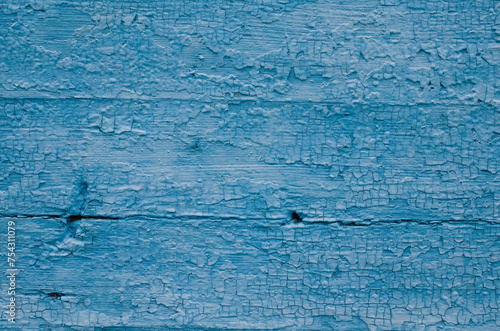 Texture of wooden boards covered with blue paint. Old wooden board covered with blue paint. Rough board surface with blue paint.