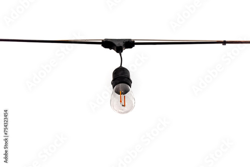 Hanging light bulb on a cable in an outdoor space on a white background