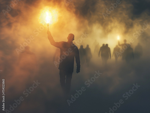 A man in carries a burning torch through heavy fog and lights the way for people. The concept of a leader and a crowd.