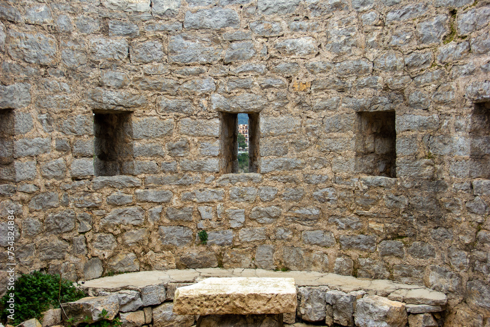 Loophole windows in the wall of an ancient ruined castle