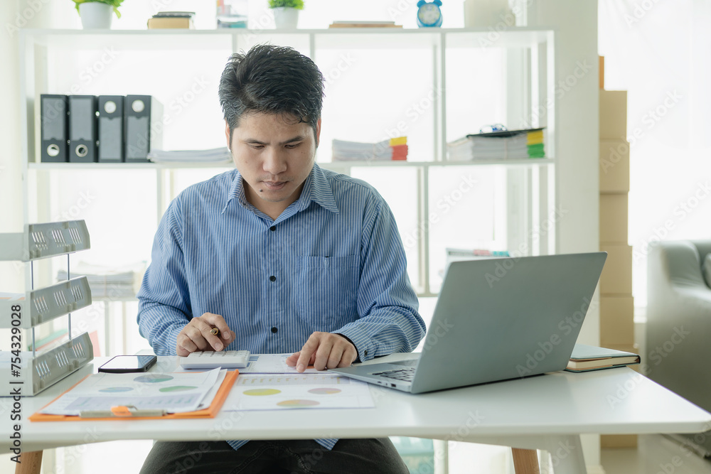 Professional Asian male salesman is presenting paper documents to customers with laptop from his home office, remote communication with online meeting. Professional Asian male salesman is presenting paper documents to customers with laptop from his home office, remote communication with online meeting.