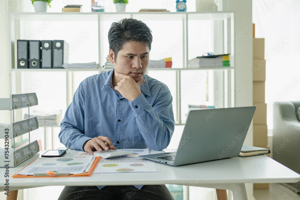 Professional Asian male salesman is presenting paper documents to customers with laptop from his home office, remote communication with online meeting. Professional Asian male salesman is presenting paper documents to customers with laptop from his home office, remote communication with online meeting.