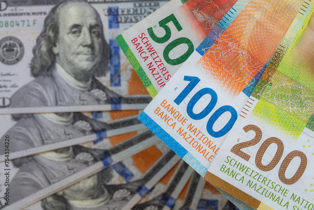 Obraz premium Closeup of 50, 100 and 200 Swiss franc banknotes and 100 dollar banknote