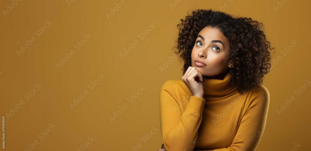 Pensive Black woman in a sweater with copy space Pensive Black woman in a sweater with copy space
