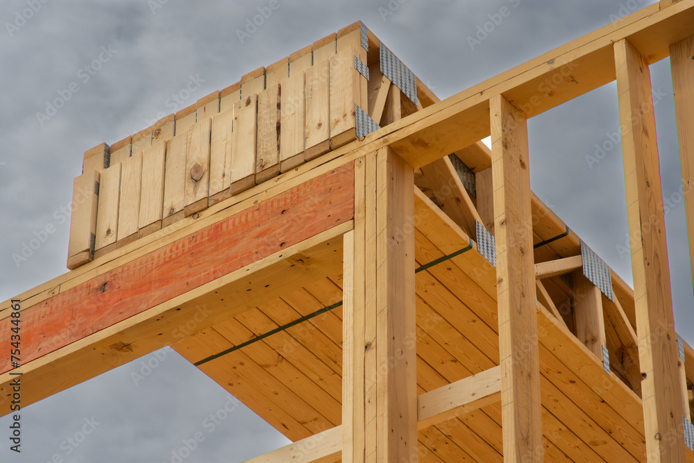 Floor joists stacked on top of first floor of multi story wood frame apartment building under construction. Floor joists stacked on top of first floor of multi story wood frame apartment building under construction.