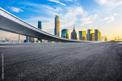 Empty asphalt road and city business buildings skyline