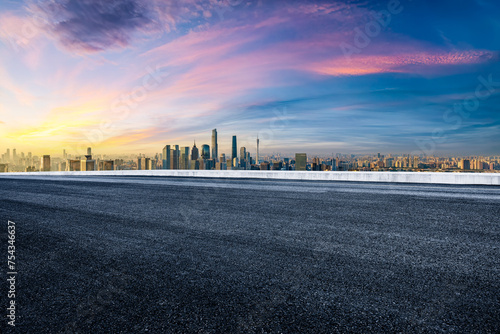 Empty asphalt road and city business buildings skyline