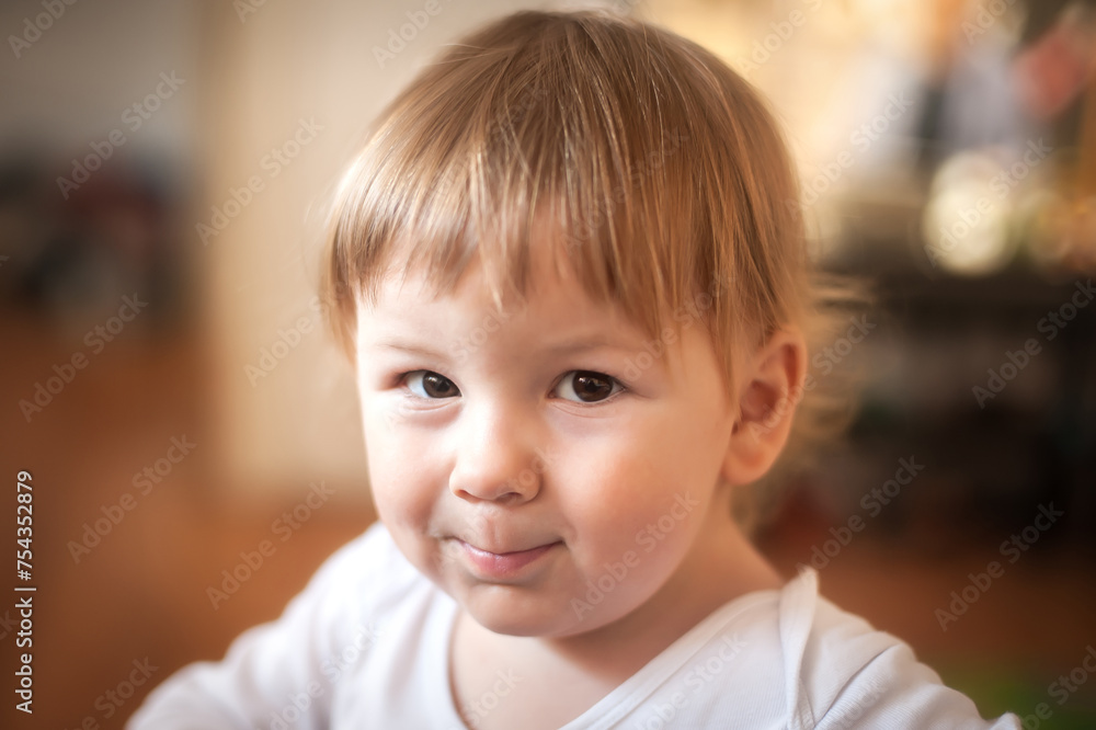 Portrait of happy cute smiling baby boy looking at camera. Joy and happiness concept. Love and family emotion Portrait of happy cute smiling baby boy looking at camera. Joy and happiness concept. Love and family emotion