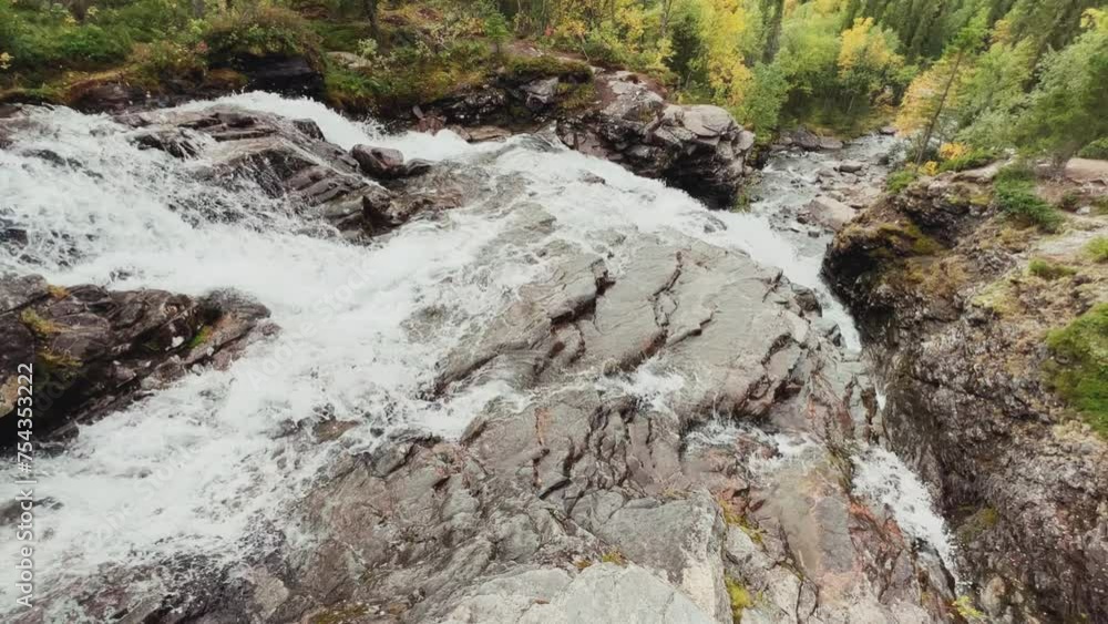A beautiful waterfall in the autumn mountains beyond the Arctic Circle in the north, in Khibiny, Murmansk region. Panoramic view of a beautiful waterfall in the mountains in autumn, Kola Peninsula 4К A beautiful waterfall in the autumn mountains beyond the Arctic Circle in the north, in Khibiny, Murmansk region. Panoramic view of a beautiful waterfall in the mountains in autumn, Kola Peninsula 4К
