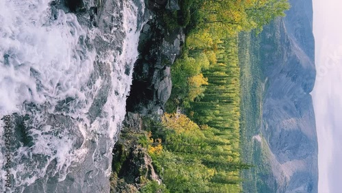 A beautiful waterfall in the autumn mountains beyond the Arctic Circle in the north, in Khibiny, Murmansk region. Panoramic view of a beautiful waterfall in the mountains in autumn, Kola Peninsula 4К photo