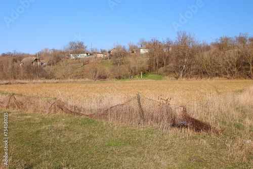 Fototapeta Naklejka Na Ścianę i Meble -  A field with a fence and trees