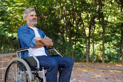 Park Serenity: Wheelchair-bound Man Finds Peace © Andrii 