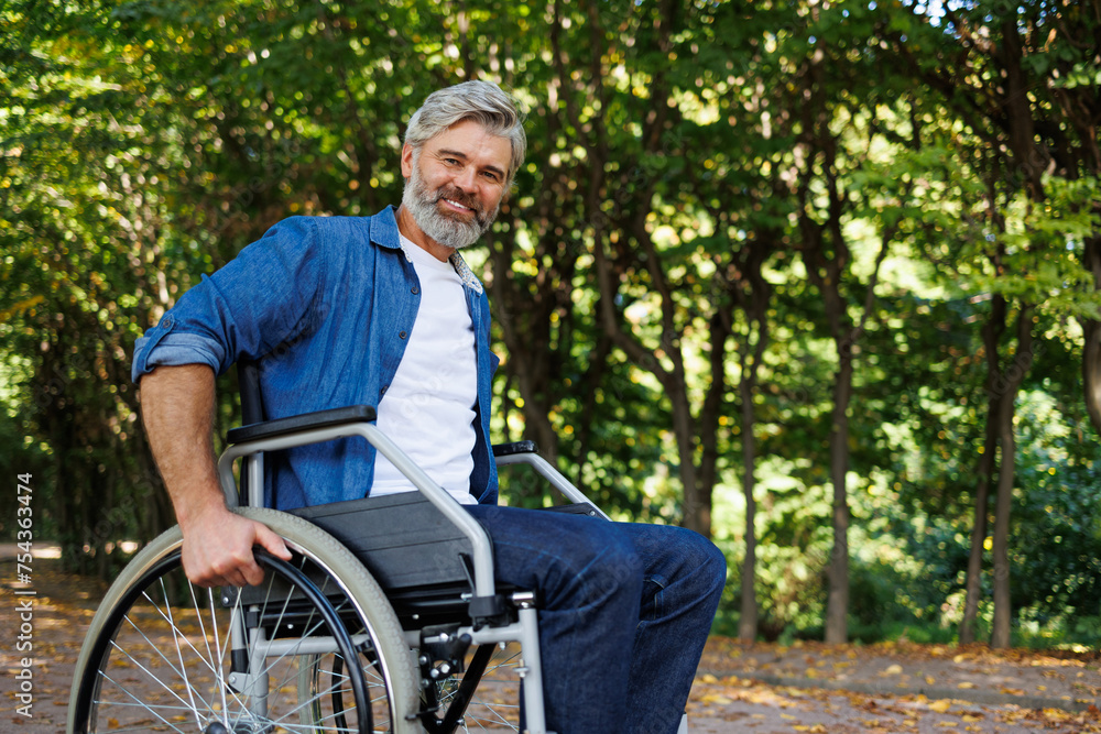 Overcoming Obstacles: Man Striving to Stand in Wheelchair Overcoming Obstacles: Man Striving to Stand in Wheelchair