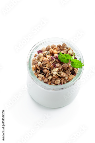 Fresh natural homemade organic yogurt with granola and grapes in a glass jar isolated on white