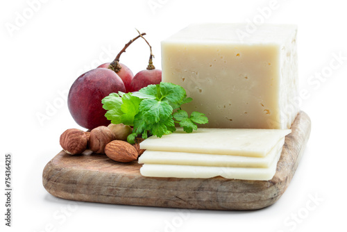 Pieces of cheese and grape on wooden board isolated on white