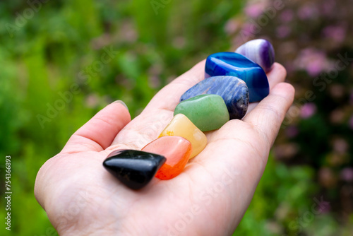 All seven colors of the chakra of semi-precious stones (minerals) on the hand. Mineralogy, isotherics photo