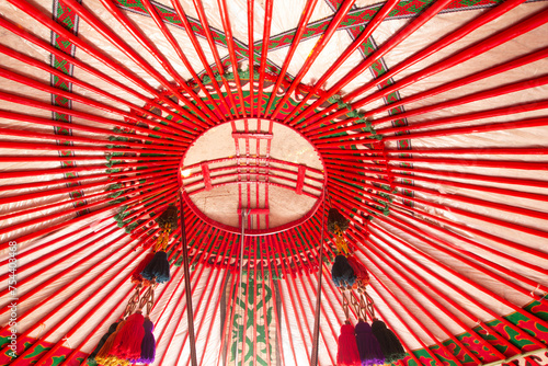 Yurt interior. Shanyrak impotant element of traditional Kyrgyz tent. Tunduk symbol in center of Kyrgyzstan national flag. National decoration on roof Embroidery and patterns of nomads central Asia.
