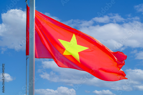 Vietnamese flag on a flagpole against the blue sky