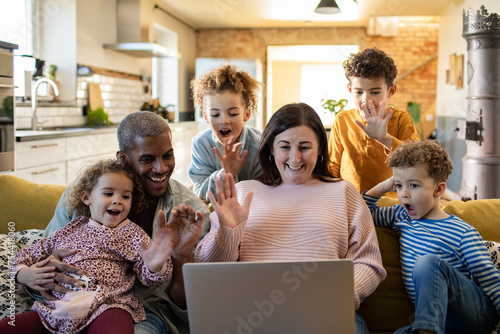 Family video call with relatives on a laptop at home photo