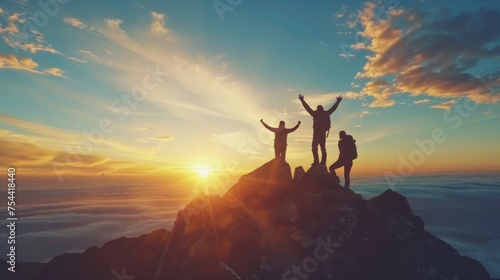 Male hiker celebrating success on top of a mountain in a majestic sunrise and Climbing group friends helping hike up .Teamwork , Helps ,Success, winner and Leadership © Sasint