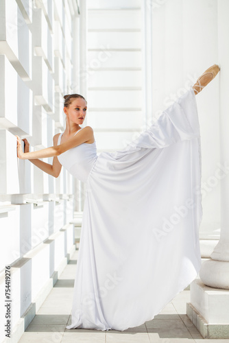 Portrait of a Russian ballerina in a white long skirt