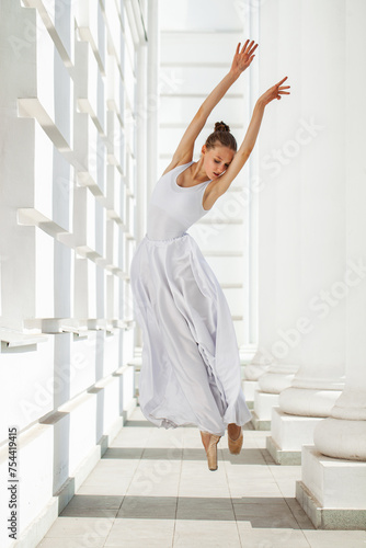 Portrait of a Russian ballerina in a white long skirt photo