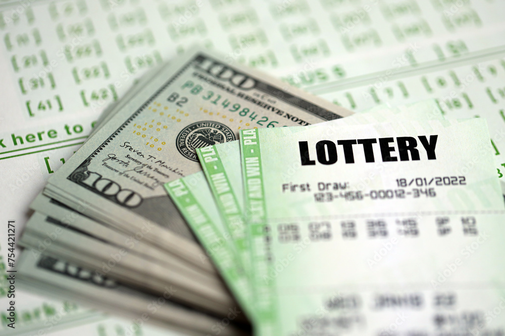 Green lottery tickets and US money bills on blank with numbers for playing lottery close up Green lottery tickets and US money bills on blank with numbers for playing lottery close up