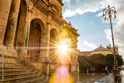 Sun shining through beautiful baroque building in Noto, Sicily, Italy
