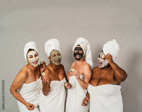 Happy multiracial women with different ages and body size having skin care spa day - People wellness and self care concept