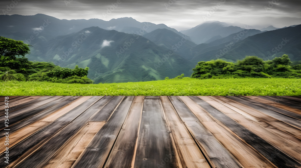 a wooden deck with tea fields and mountains behind it