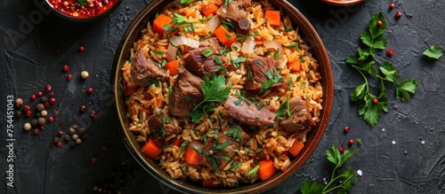 A bowl filled with Turkish pilaf made with rice, meat, and a variety of colorful vegetables. photo