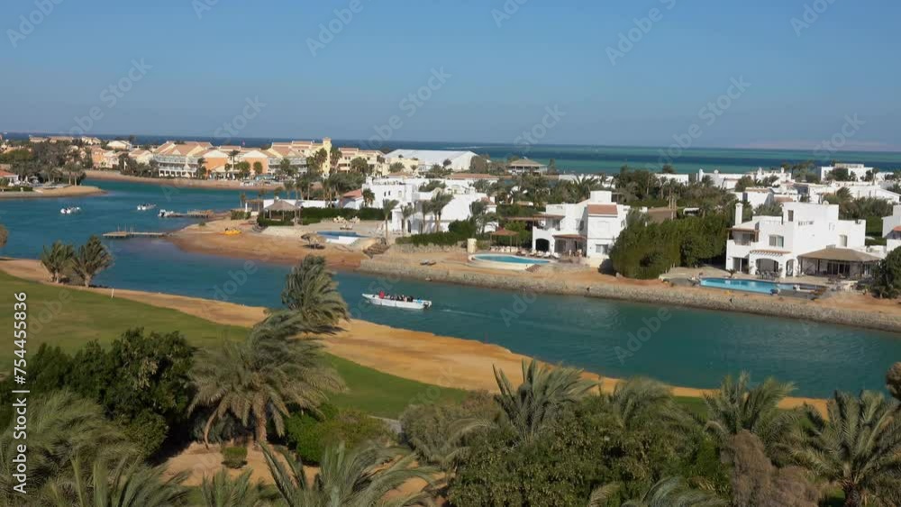Aerial view on the artificial golf fields surrounded by date palm trees in the African desert of El Gouna, Egypt Aerial view on the artificial golf fields surrounded by date palm trees in the African desert of El Gouna, Egypt