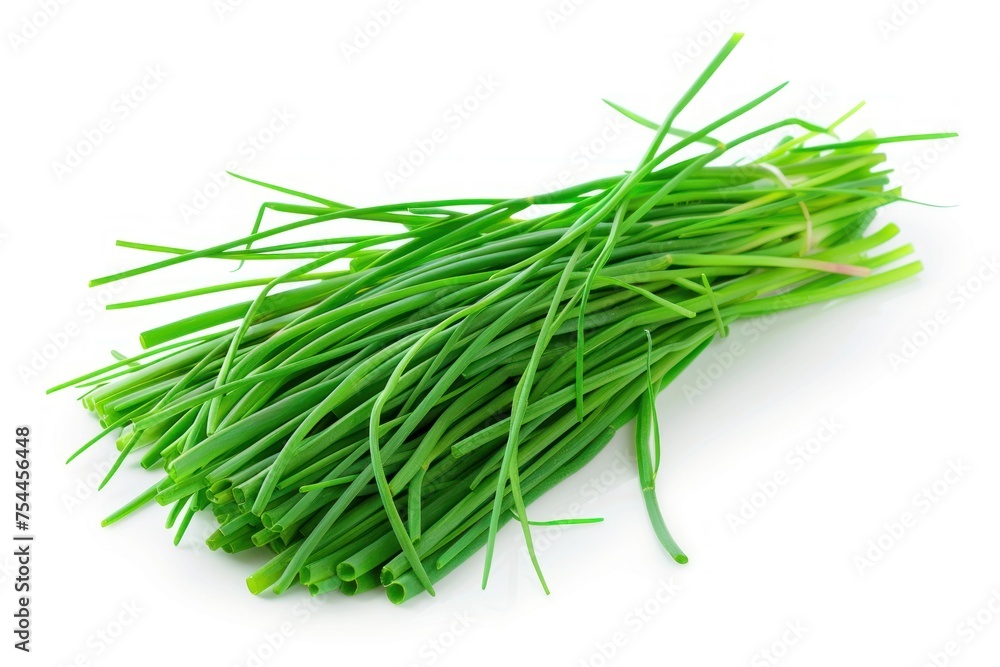 A bunch of chives are piled on a white background. The herbs are fresh and green, and they look like they are ready to be used in a recipe
