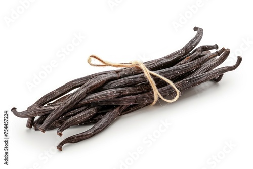 A bunch of black, unopened vanilla beans are tied together