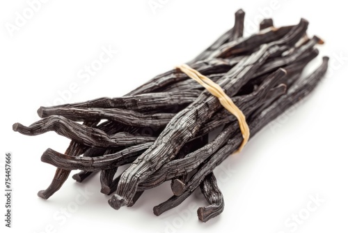 A bunch of black vanilla beans are tied together. The beans are long and thin, and they are all the same size