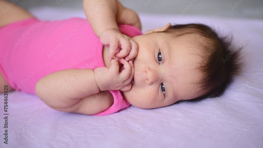 A newborn baby lying on blanket. Infant lying on purple blanket or cover. A newborn baby lying on blanket. Infant lying on purple blanket or cover.