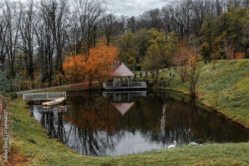 A cloudy day and a wooden gazebo. Landscape with a lake. Mountain landscape, lake and mountain range, Caucasus. A colorful landscape on a lake in the forest. 