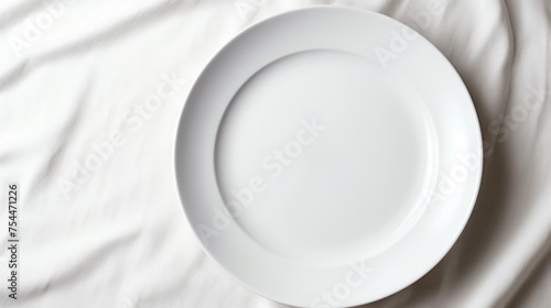 A white plate sitting on top of a bed. Perfect for home decor concepts