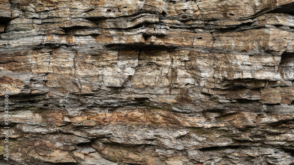 A detailed view of ancient rock strata, revealing the intricate patterns and history etched into the geological layers over millennia A detailed view of ancient rock strata, revealing the intricate patterns and history etched into the geological layers over millennia