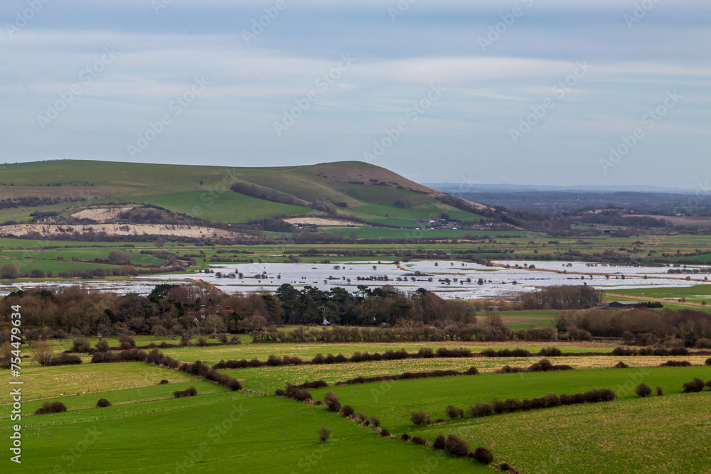 Looking out from Kingston Ridge in Sussex towards Mount Caburn, with flooded fields due to recent heavy rain