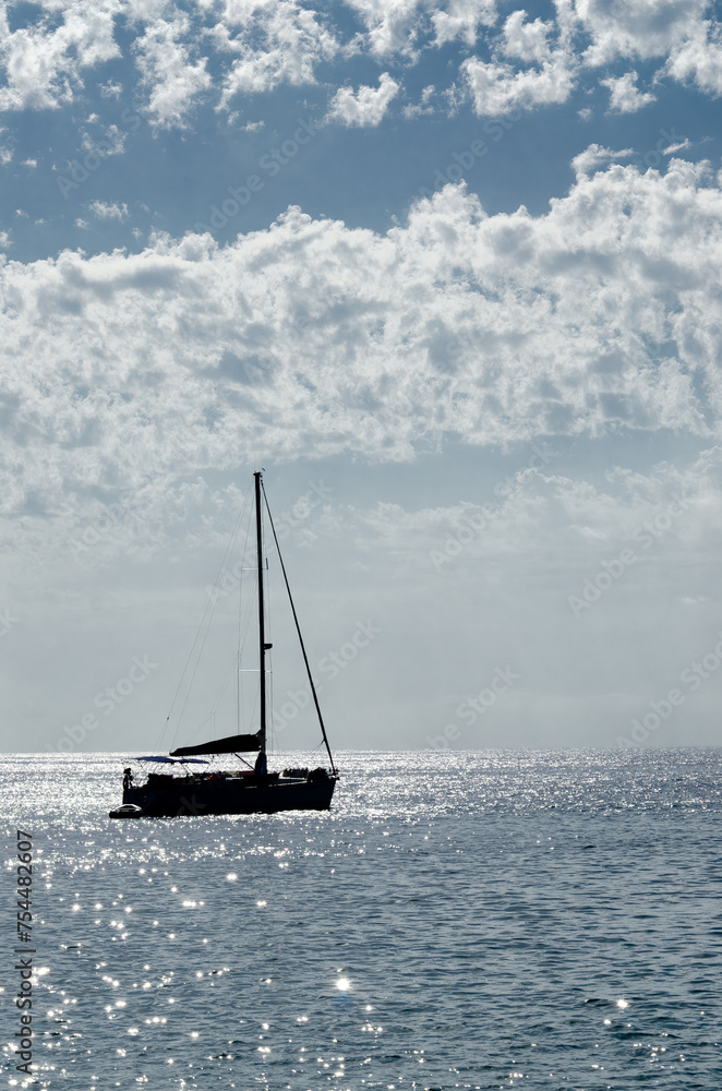Silhouette of a sailboat against the sky