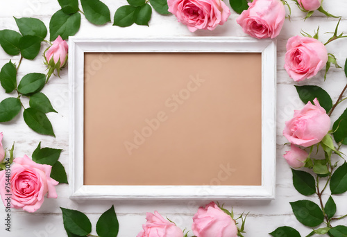 Pink rose flowers with empty photo frame on white wooden background. Valentines, Mother's, Women's Day. Flat lay, top view, copy space. 