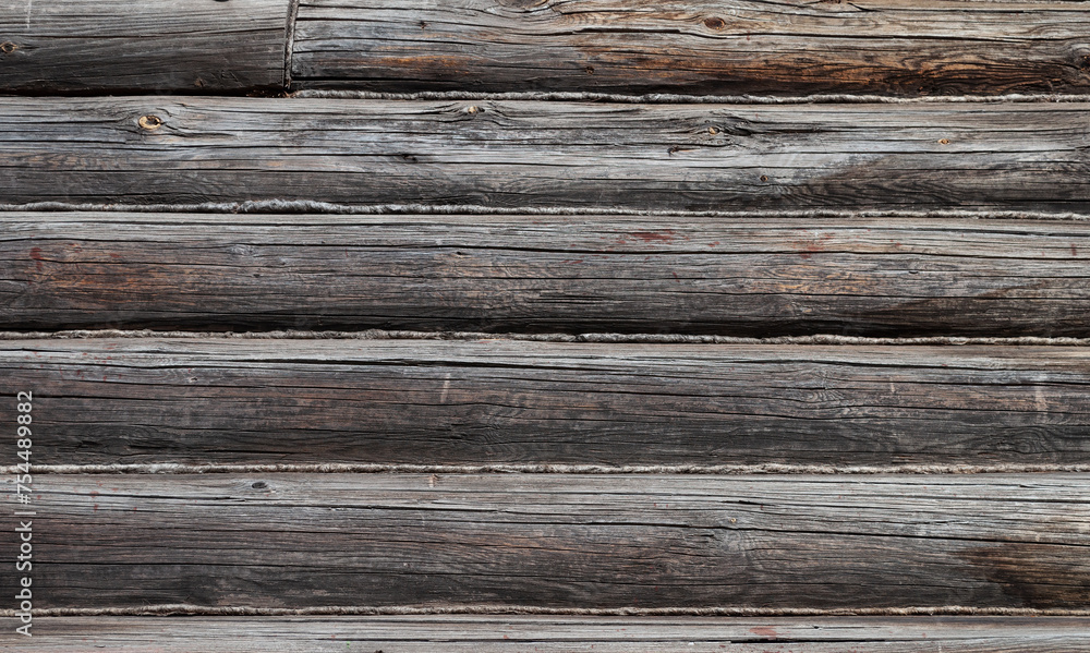 Texture of old weathered cracked unpainted wooden log wall Texture of old weathered cracked unpainted wooden log wall