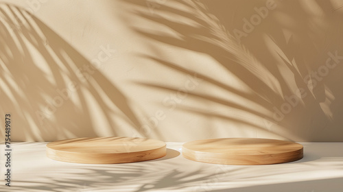 Two wooden round tray podium in sunlight, leaf shadow on beige wall background