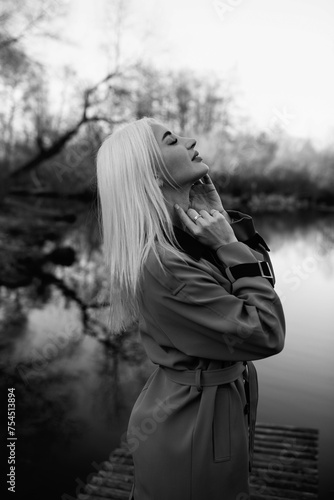 Portrait of a young beautiful blonde woman outdoors. Black and white photo.