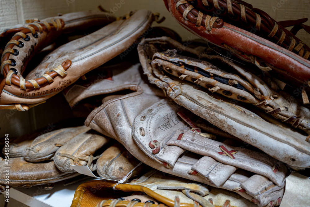 close up of old baseball gloves